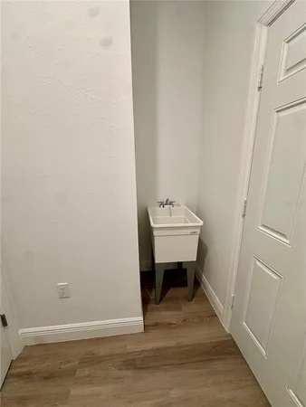 a view of a room with a bench and wooden floor