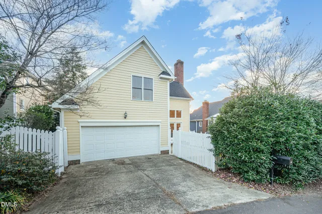 a view of a house with wooden fence