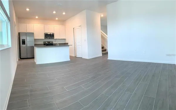 a kitchen with stainless steel appliances a refrigerator and a stove top oven