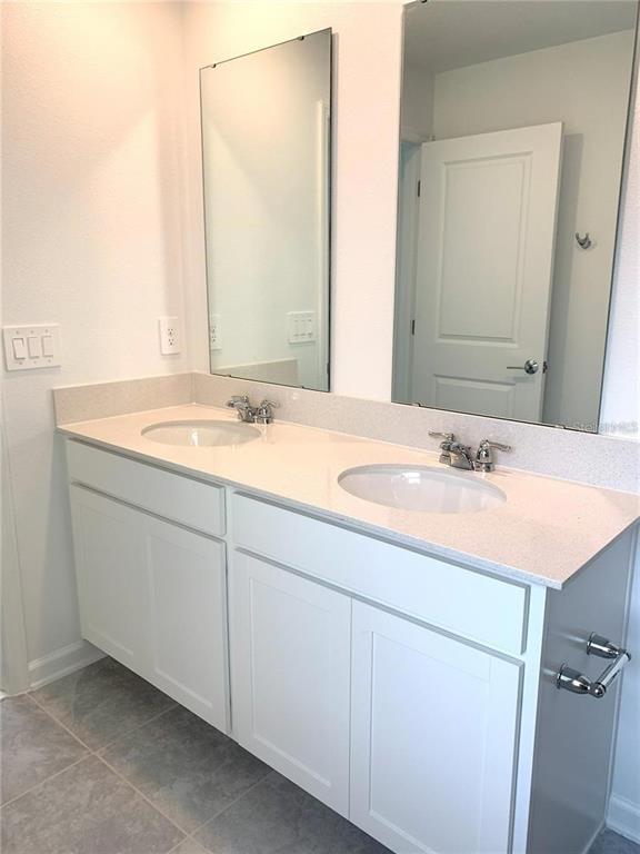15609 Water Spring Boulevard Winter Garden, FL 34787 - Photo 14 of 36 a bathroom with a granite countertop sink and a mirror