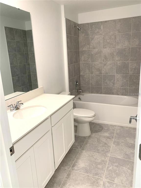 15609 Water Spring Boulevard Winter Garden, FL 34787 - Photo 18 of 36 a bathroom with a sink a toilet and a bathtub