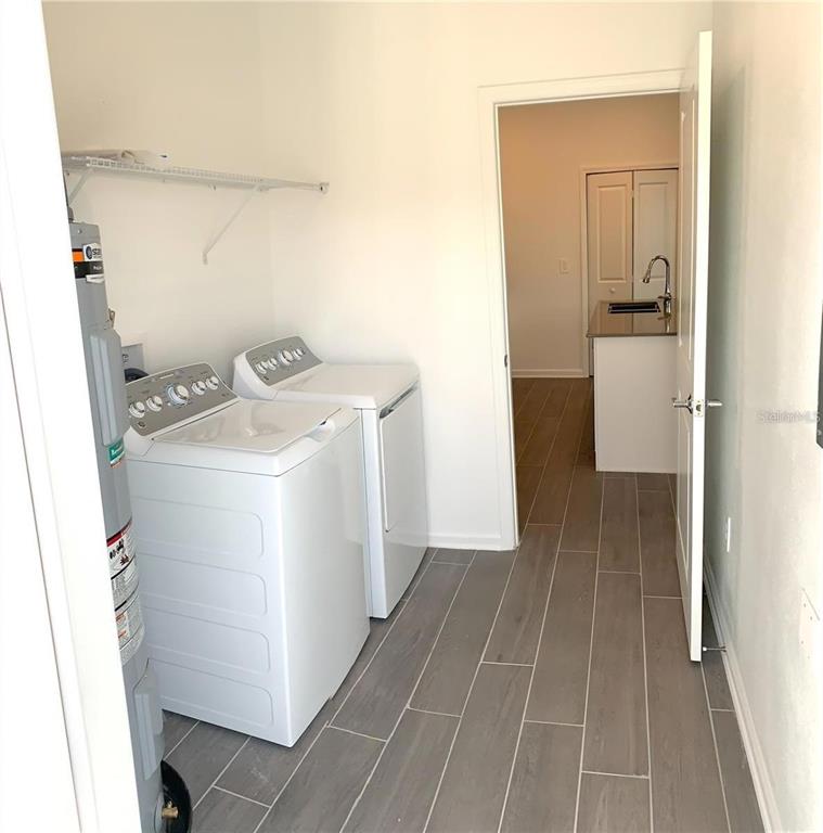 15609 Water Spring Boulevard Winter Garden, FL 34787 - Photo 19 of 36 a utility room with dryer and washer