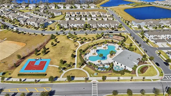 a view of a swimming pool with a lawn chairs under an umbrella