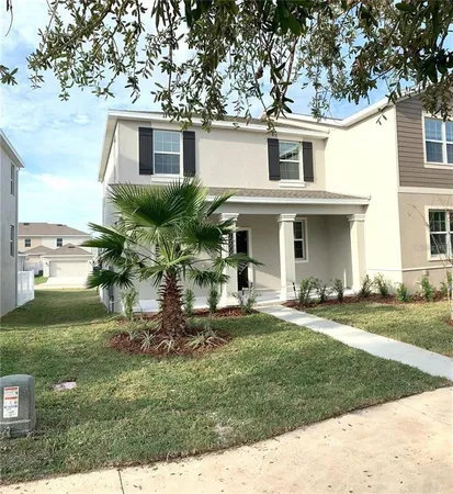 a front view of a house with a garden and patio