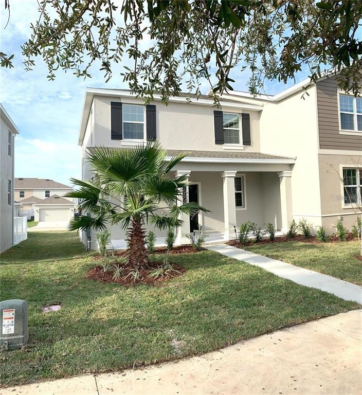 15609 Water Spring Boulevard Winter Garden, FL 34787 - Photo 3 of 36 a front view of a house with a garden and patio