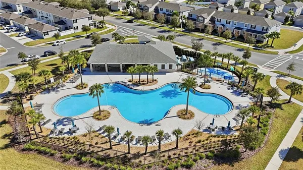 an aerial view of residential houses with outdoor space