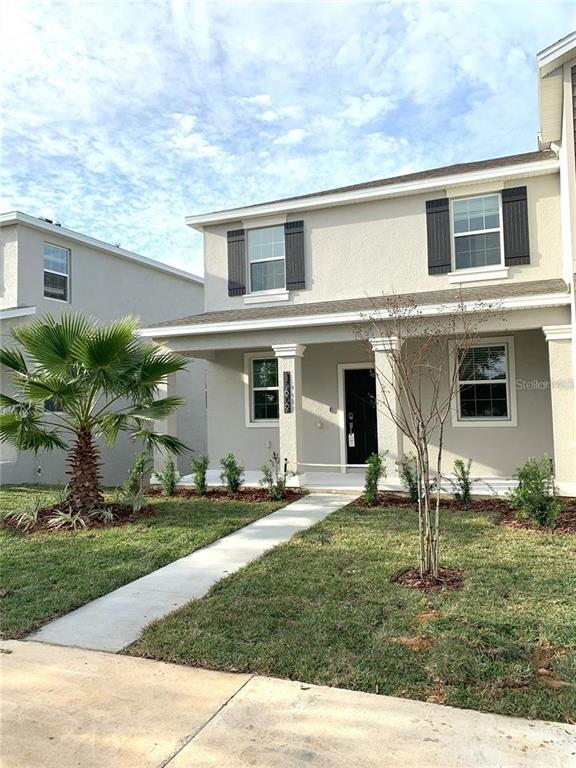 15609 Water Spring Boulevard Winter Garden, FL 34787 - Photo 6 of 36 front view of a house with a yard