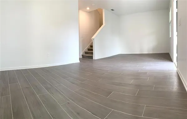 a view of a hallway with wooden floor