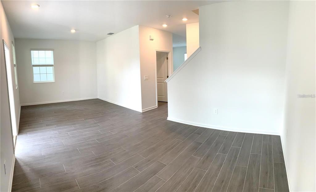 15609 Water Spring Boulevard Winter Garden, FL 34787 - Photo 9 of 36 a view of a hallway with wooden floor