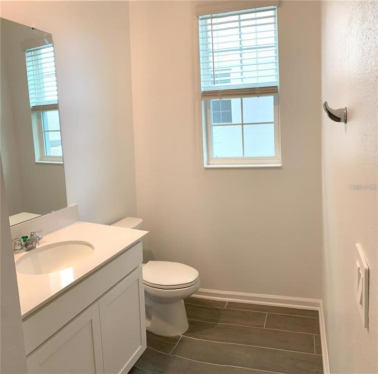15609 Water Spring Boulevard Winter Garden, FL 34787 - Photo 10 of 36 a bathroom with a sink toilet and window