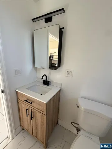 a bathroom with a sink a toilet and tub