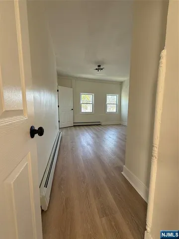 an empty room with wooden floor