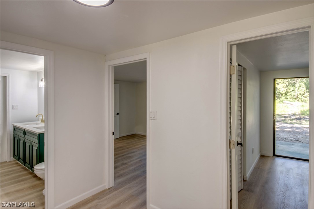 275 Trader Road Fort Denaud, FL 33935 - Photo 16 of 32 a view of a hallway with wooden floor and closet