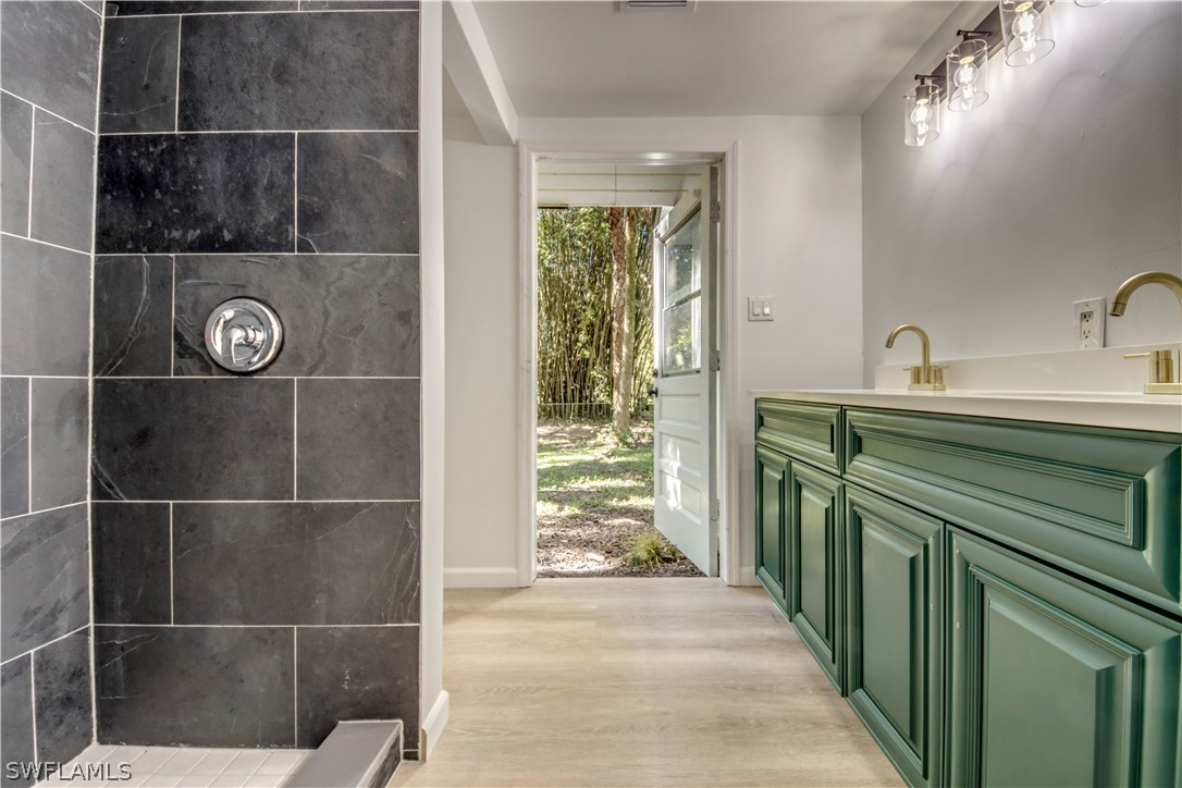 275 Trader Road Fort Denaud, FL 33935 - Photo 18 of 32 a bathroom with a double vanity sink and mirror