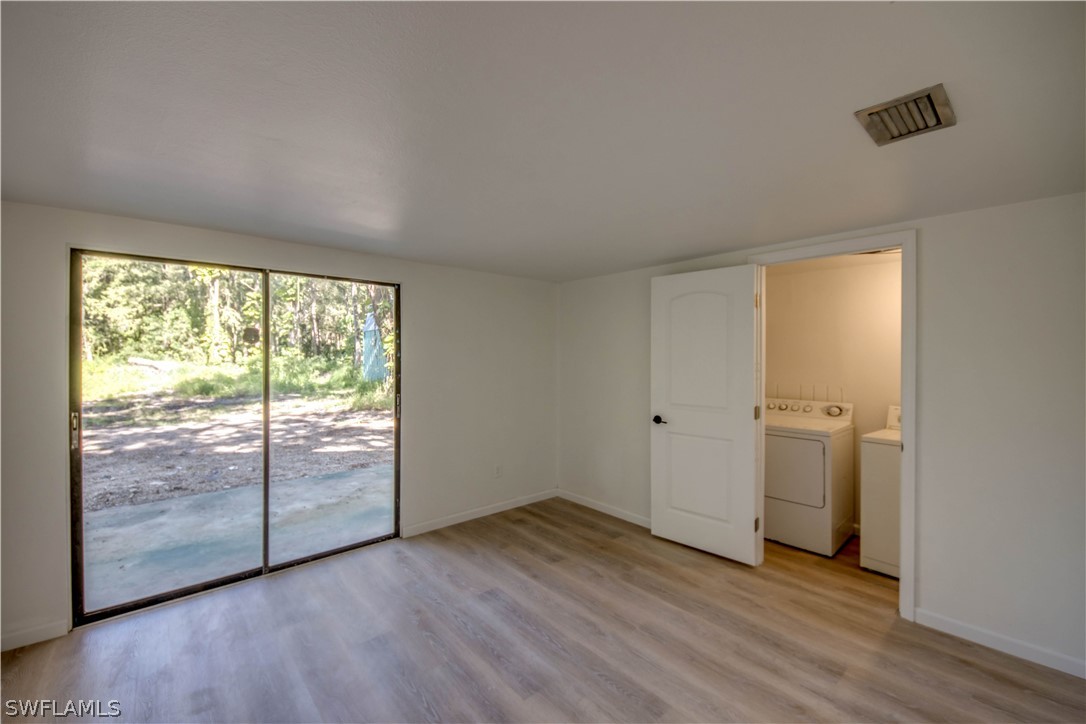 275 Trader Road Fort Denaud, FL 33935 - Photo 20 of 32 a view of a room with wooden floor and doors