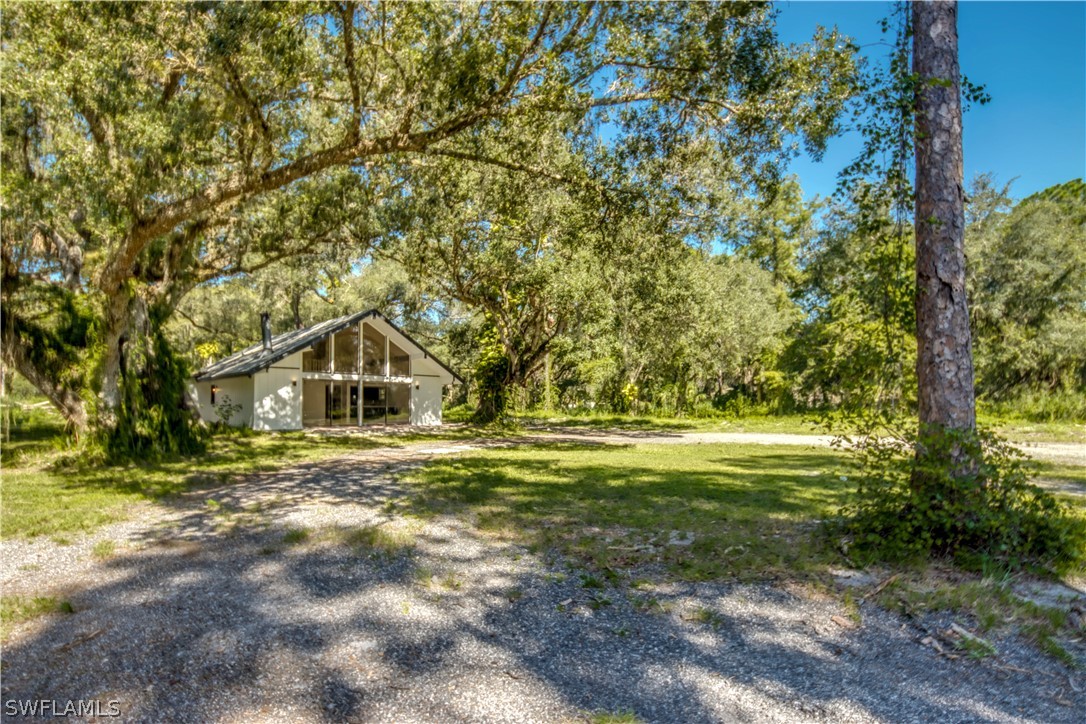 275 Trader Road Fort Denaud, FL 33935 - Photo 2 of 32 a front view of a house with a yard