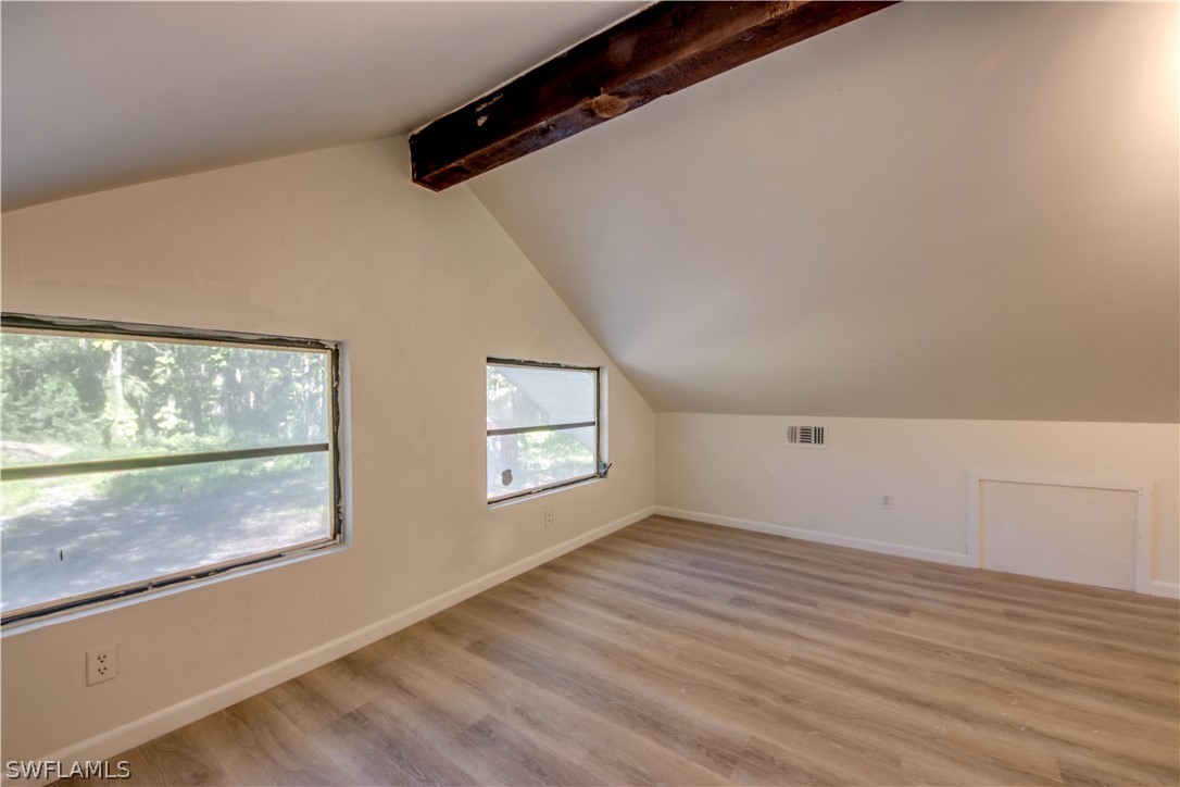 275 Trader Road Fort Denaud, FL 33935 - Photo 27 of 32 an empty room with wooden floor and windows