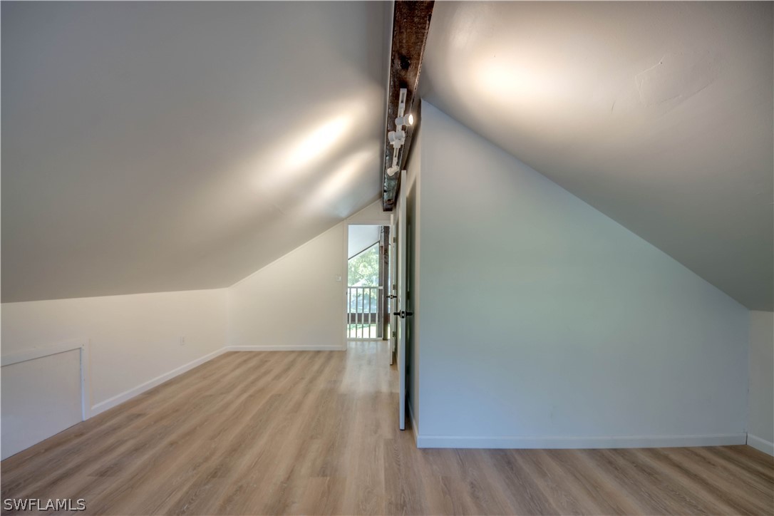 275 Trader Road Fort Denaud, FL 33935 - Photo 28 of 32 an empty room with wooden floor and windows