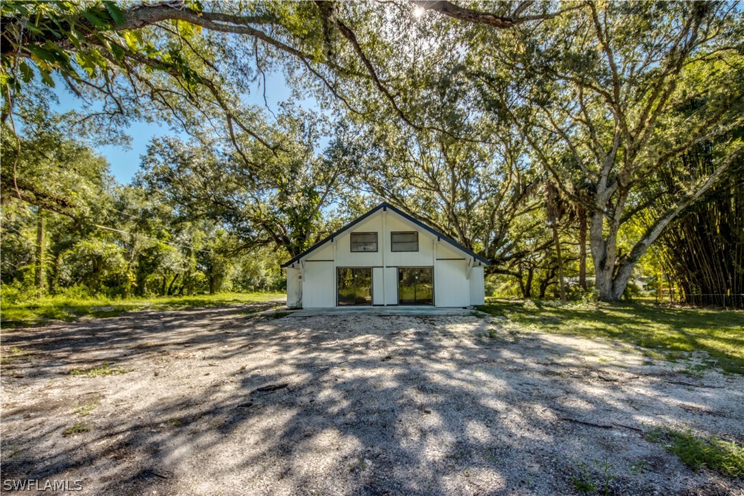 275 Trader Road Fort Denaud, FL 33935 - Photo 29 of 32 a dirt road with trees in the background