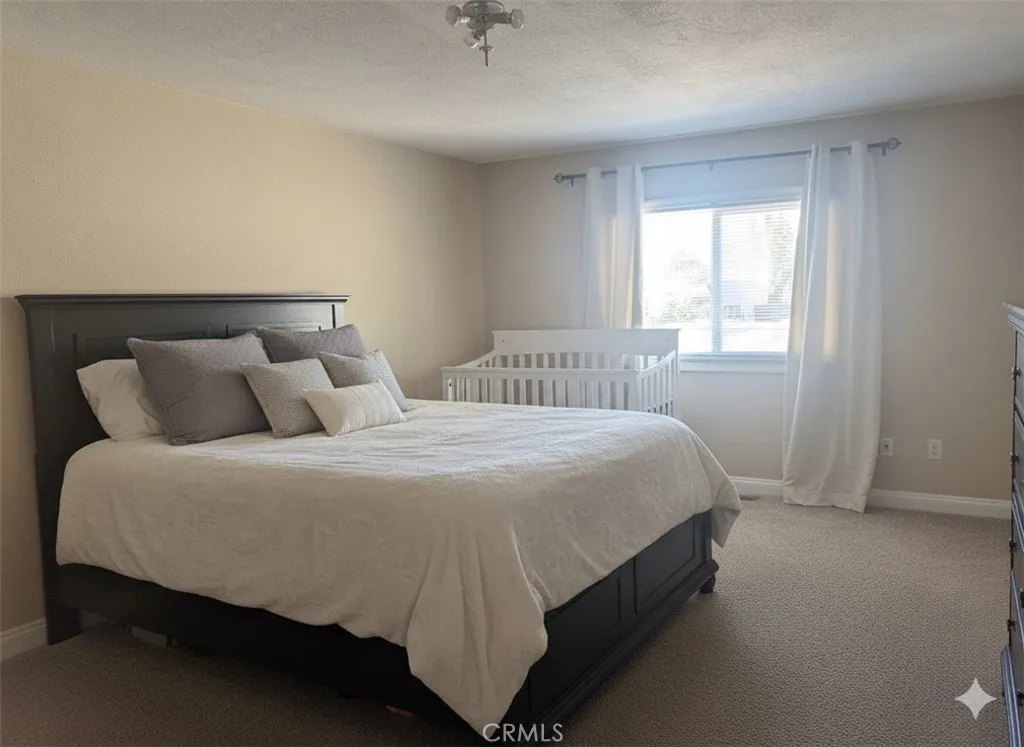15181 Van Buren, Unit 47 Riverside, CA 92504 - Photo 14 of 20 a bedroom with a bed and window