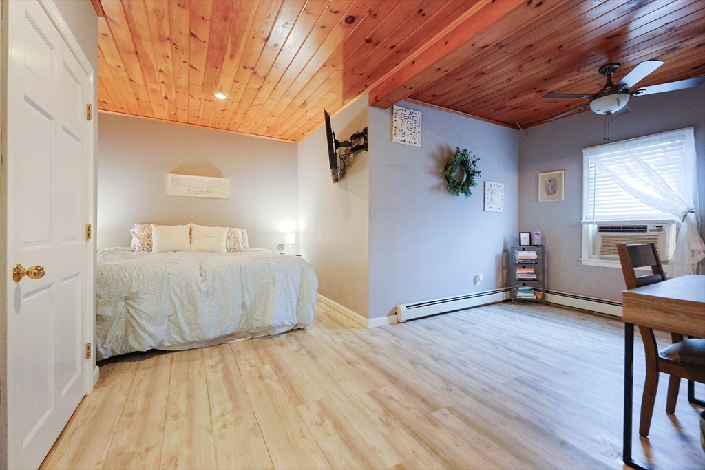 273 Tremont Street Fall River, MA 02720 - Photo 17 of 37 a spacious bedroom with a bed and a table