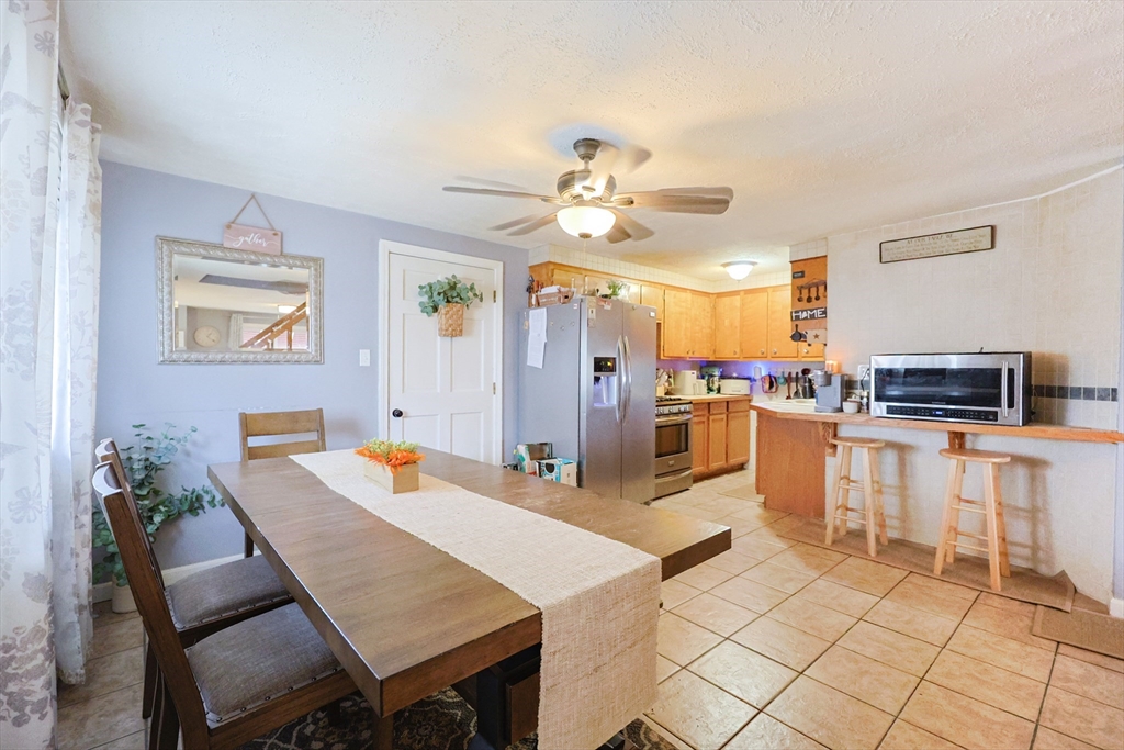 273 Tremont Street Fall River, MA 02720 - Photo 7 of 37 a open kitchen with white cabinets and stainless steel appliances
