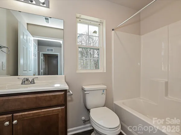 a bathroom with a sink toilet vanity tub and shower
