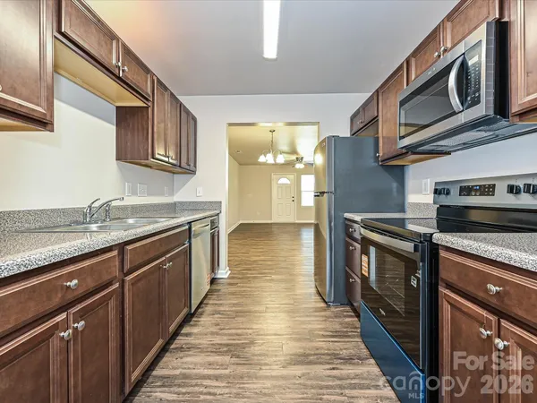 a kitchen with stainless steel appliances granite countertop a sink and stove top oven