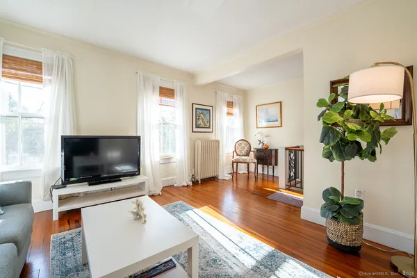 a living room with furniture and wooden floor
