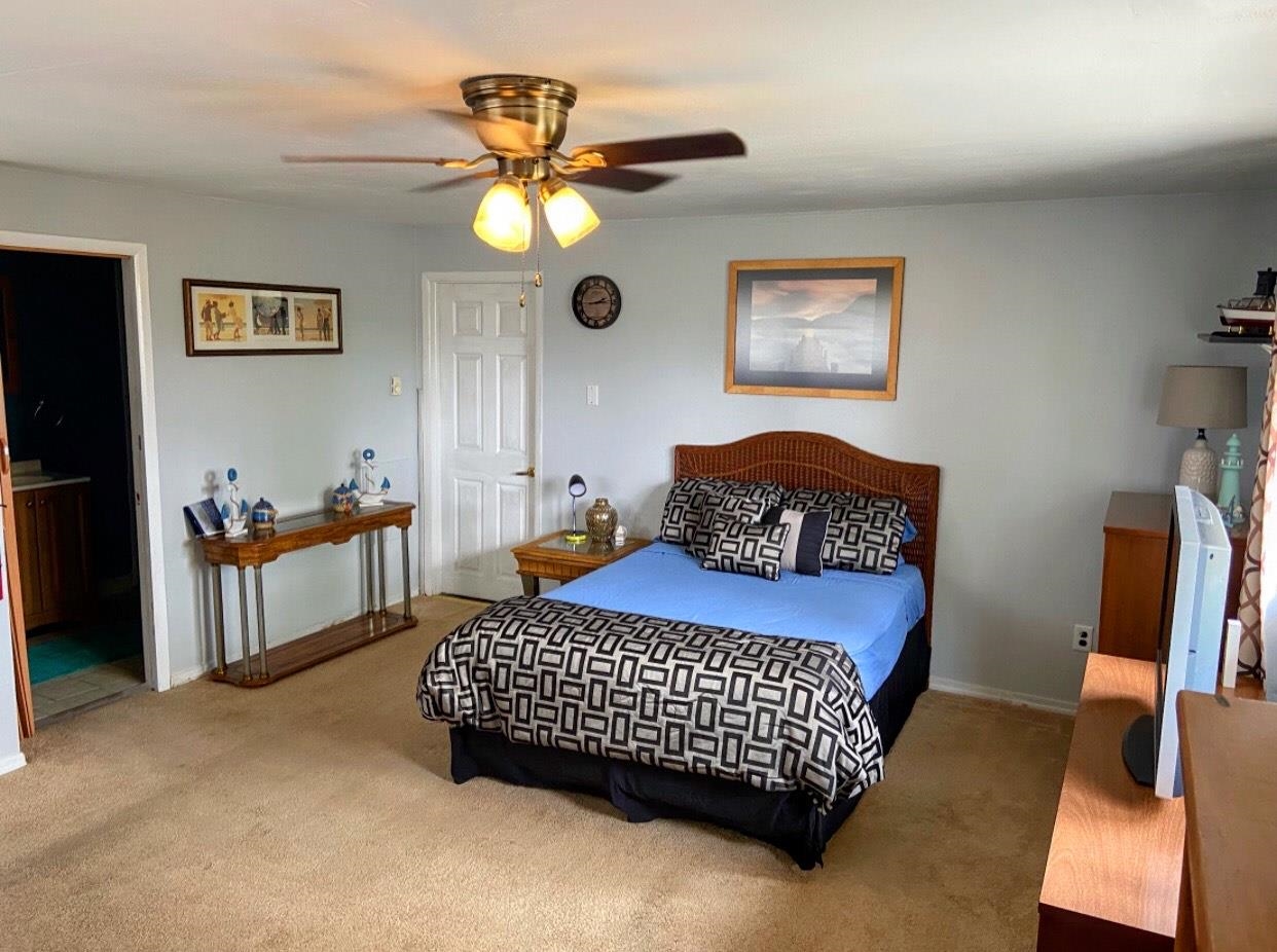 210 South Railroad Avenue Rio Grande, NJ 08242 - Photo 15 of 36 a bedroom with a bed and a chandelier