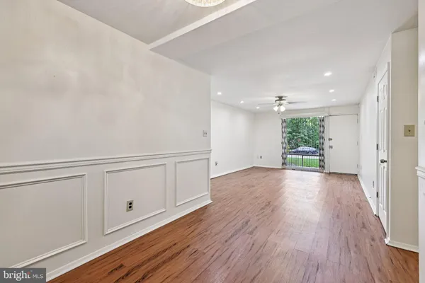 a view of an empty room with wooden floor