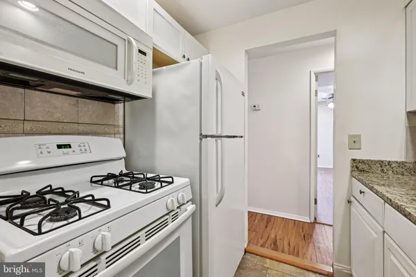 a kitchen with a stove and a refrigerator
