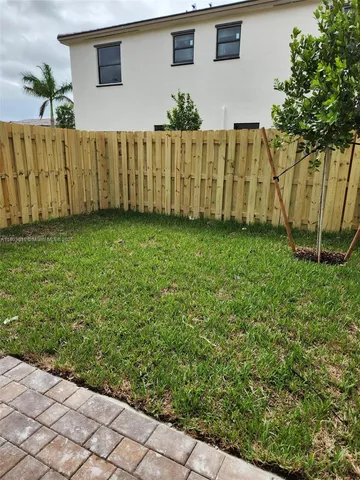 a view of a house with wooden fence