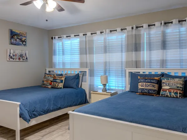 a bedroom with bed and a large window
