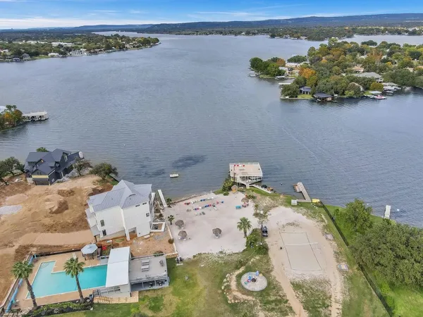 an aerial view of a house with a lake view
