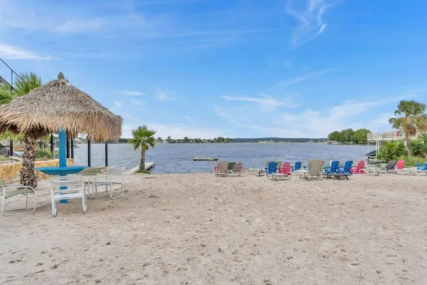 a view of a terrace with a table and chairs under an umbrella