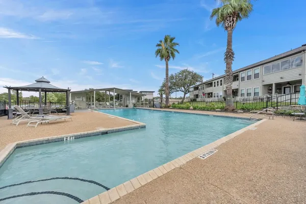 a view of a swimming pool and a yard