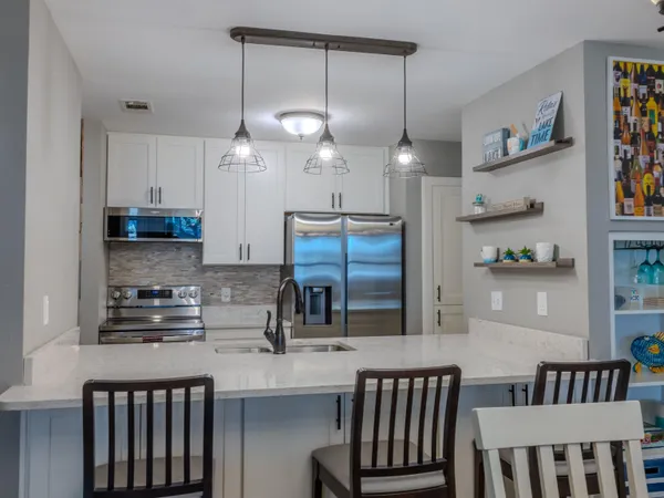 a kitchen with a sink cabinets and window