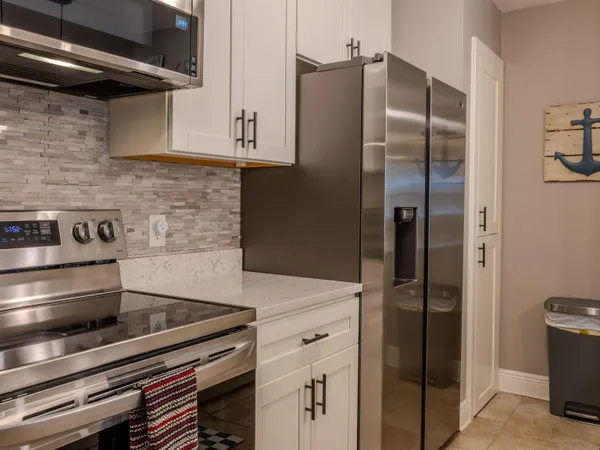 a kitchen with stainless steel appliances granite countertop a refrigerator and a stove