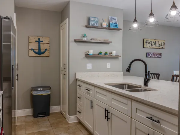 a close view of a sink and cabinets
