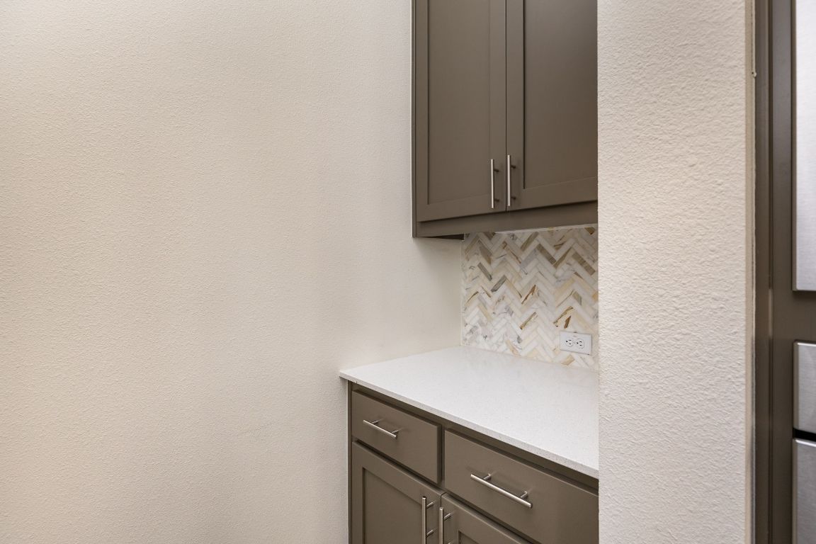 2401 McBee Street Austin, TX 78723 - Photo 14 of 36 Detailed view of backsplash and a textured wall
