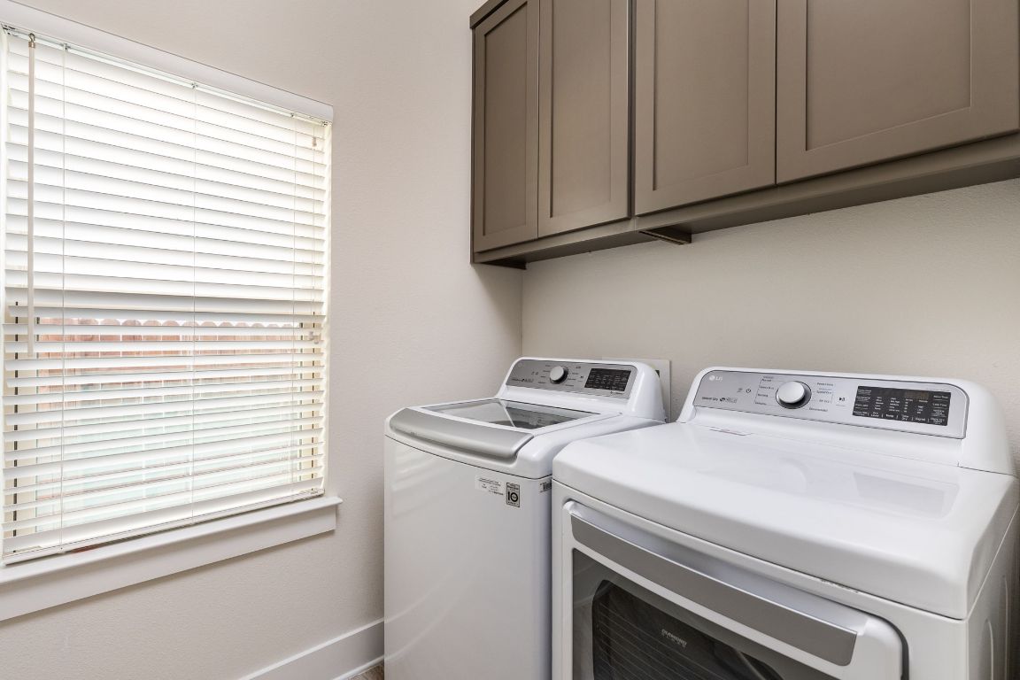 2401 McBee Street Austin, TX 78723 - Photo 15 of 36 Laundry area with washer and dryer and cabinet space