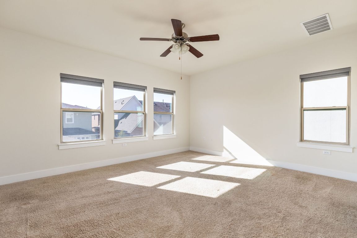 2401 McBee Street Austin, TX 78723 - Photo 20 of 36 Unfurnished room with light carpet and ceiling fan