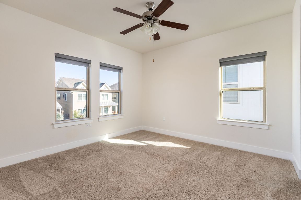 2401 McBee Street Austin, TX 78723 - Photo 26 of 36 Spare room featuring light carpet and ceiling fan