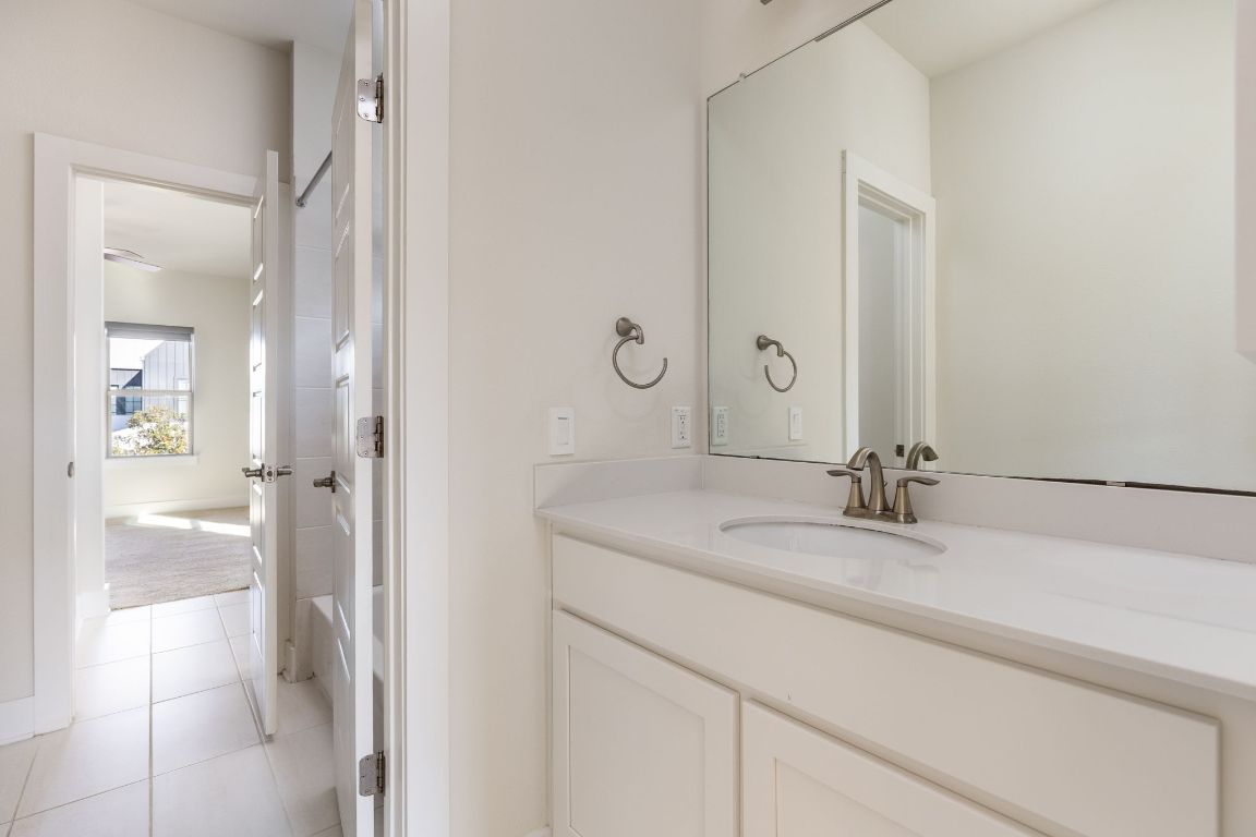 2401 McBee Street Austin, TX 78723 - Photo 31 of 36 Bathroom with vanity and light tile patterned floors