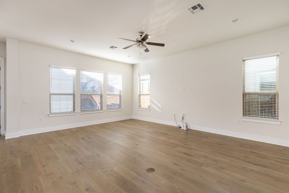 2401 McBee Street Austin, TX 78723 - Photo 6 of 36 Spare room featuring wood finished floors, recessed lighting, and ceiling fan