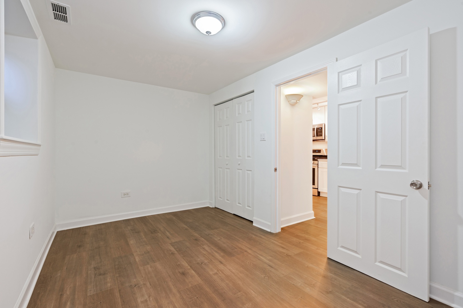 1734 West Erie Street, Unit G Chicago, IL 60622 - Photo 14 of 18 an empty room with wooden floor