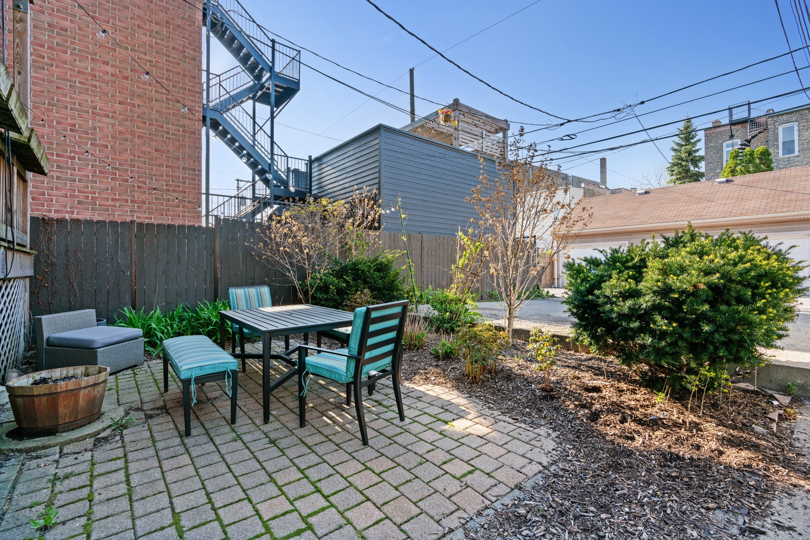 1734 West Erie Street, Unit G Chicago, IL 60622 - Photo 18 of 18 a backyard of a house with table and chairs