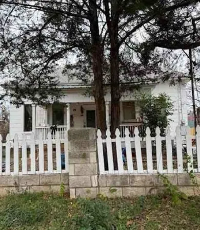 a view of a house with wooden fence