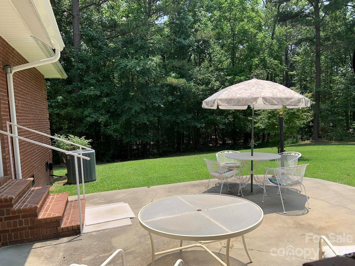 2403 Pinckney Road Chester, SC 29706 - Photo 18 of 19 a view of a backyard with table and chairs under an umbrella